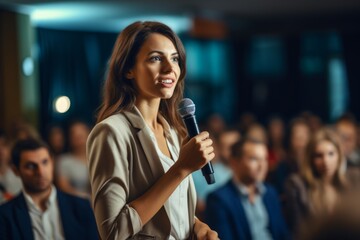 Interaction between a female manager and the audience as she asks a question during a business seminar - obrazy, fototapety, plakaty
