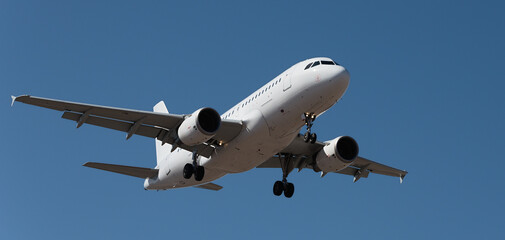 The plane lands.Airplane, passengers flying in the blue sky, preparing to land at the airport