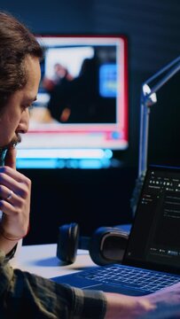 Vertical video Experienced programmer writes code on laptop screen while in apartment office using Java programming languages. Developer remotely working on fixing database errors while working from