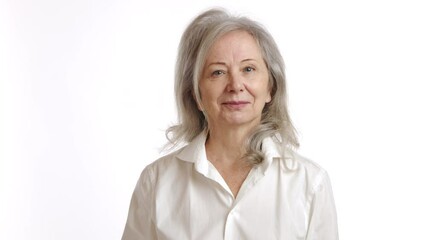 An elderly woman thoughtfully examines a blister pack of pills, shakes her head in disapproval, and decisively discards the medication, signaling the importance of cautious health management. 