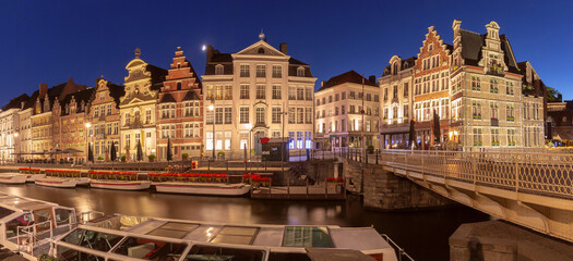 Naklejka premium Medieval houses on quay of Leie river at night, Old Town of Ghent, Belgium