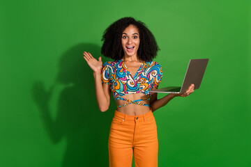 Photo of young and inexperienced marketing specialist girl with chevelure holding netbook interview isolated on green color background - obrazy, fototapety, plakaty