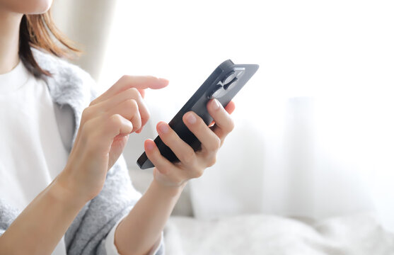 スマホを操作する女性の手元
