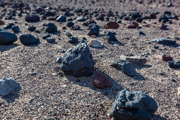 Black lava rocks in the dry hot Mojave Desert in California in a valley near Death Valley National Park