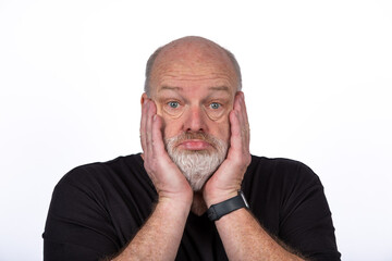 Stressed Middle-Aged Man in Black T-Shirt Expressing Shock and Despair on White Background