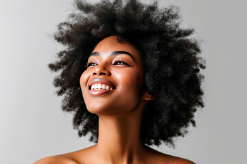 Hair beauty and happy black woman with afro isolated on grey