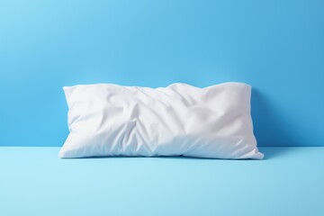 White cotton pillow on blue background