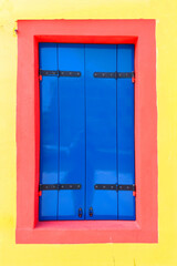 colorful facade of an old fisher house in the village of Burano near Venice
