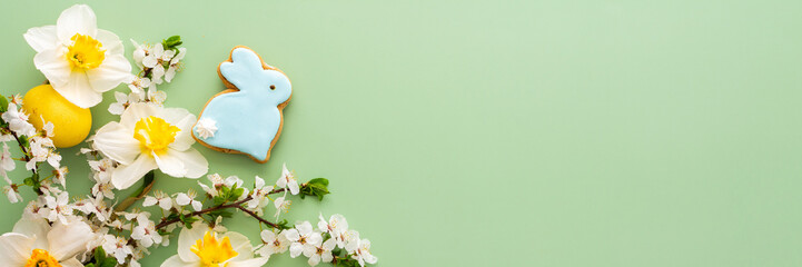 Festive banner with spring flowers and naturally colored eggs and Easter bunnies, white daffodils...