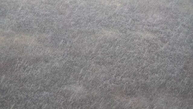 It is snowing. Winter snowy weather. Heavy snowfall over the forest top view. Snow.