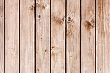 Warm color wood background. Grunge wood texture. Raw brown wooden plank wall background. Rustic tree desk with knots pattern. Countryside architecture. Village building board construction.