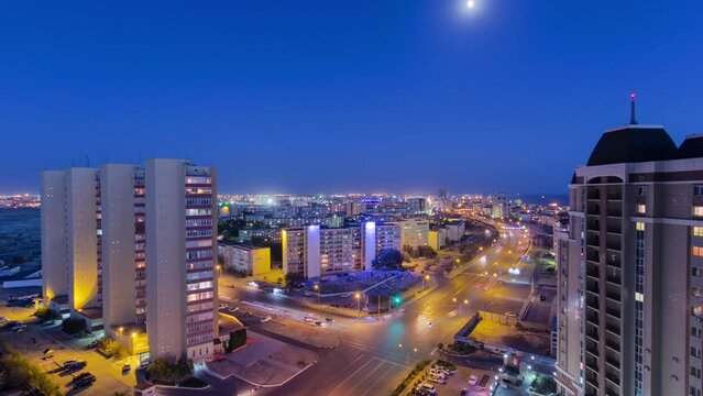 Dusk to Night Panorama: Aktau City on the Caspian Sea Shore Timelapse. Aerial Top View Showcasing the Transition from Sunset to Night, Illuminating the Coastal Beauty of Kazakhstan