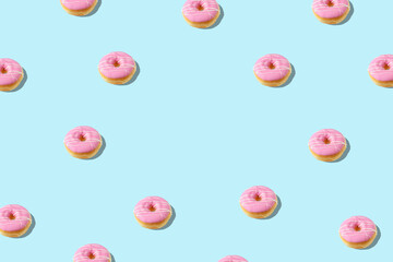 Creative pattern with donut on blue background. Minimal summer concept.