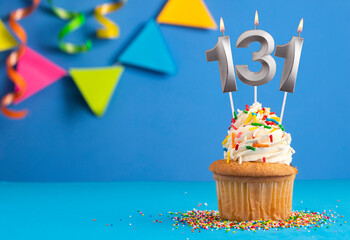 Birthday cupcake with candle number 131 - Blue background