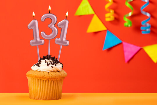 Number 131 candle - Birthday cupcake on orange background with bunting