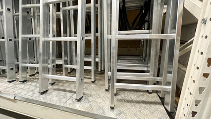 Aluminum stairs in the store, Stairs of ladder for construction in shop, New aluminum stepladders in tool store, nobody, Many new step ladder display on the tool store (shop).