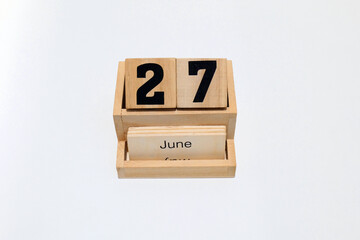 27th of June wooden perpetual calendar. Shot close up isolated on a white background