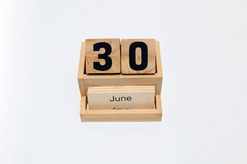 30th of June wooden perpetual calendar. Shot close up isolated on a white background