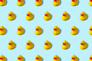 Trendy summer pattern with yellow rubber duck on bright blue background. Minimal summer concept.