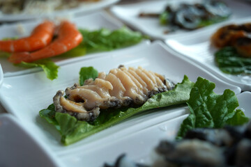 Fresh raw abalone sashimi is served.