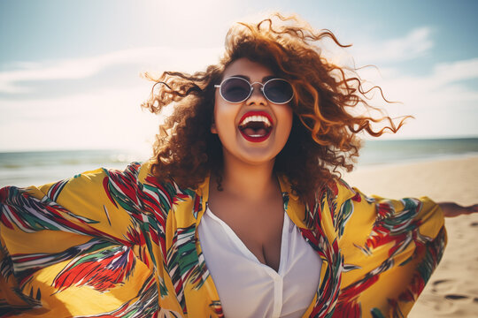 Cheerful young woman laughing on a sunny beach, ideal for vacation and summer themes. Plus size model