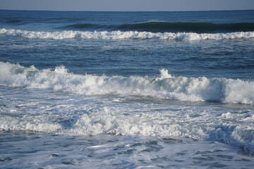 Winter sea waves splashing with white foam