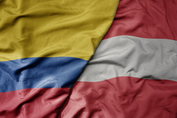 big waving national colorful flag of austria and national flag of colombia .