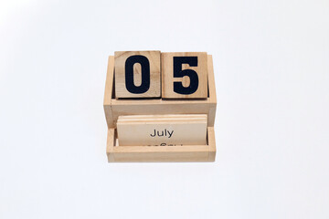 5th of July wooden perpetual calendar. Shot close up isolated on a white background