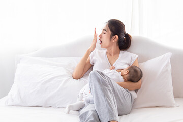 Selective focus young Asian beautiful mother hold newborn baby 0-1 month in her arms with love,...