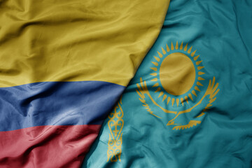 big waving national colorful flag of kazakhstan and national flag of colombia .