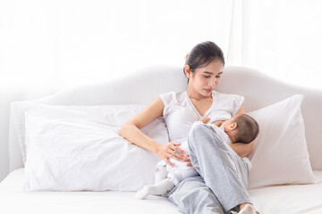 Selective focus young Asian beautiful mother hold newborn baby 0-1 month in her arms with love,...