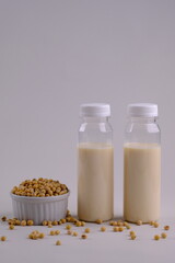 Susu Kedelai, soy milk served in a clear plastic bottle, containing vegetable protein, vitamin D, B12, calcium, omega 3. Suitable for vegans and vegetarians. Made from soybeans, water and sugar.