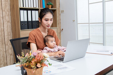 Asian parent working while looking after a young baby or toddler, single mother businesswoman working from home multitask nursing infant using technology modern laptop meeting online at home office