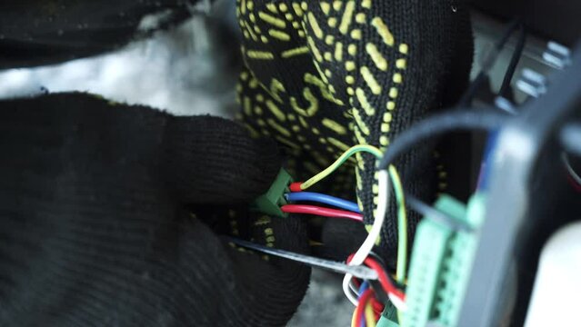 Electrician installs wiring using Connectors for connecting wires in automation and electronics equipment. Connection of electrical wires of electrical appliances