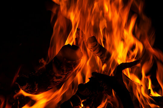 A fire is burning in a pile of wood.