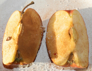 Apples in quarters sprinkled with cinnamon and sugar, a healthy snack. 