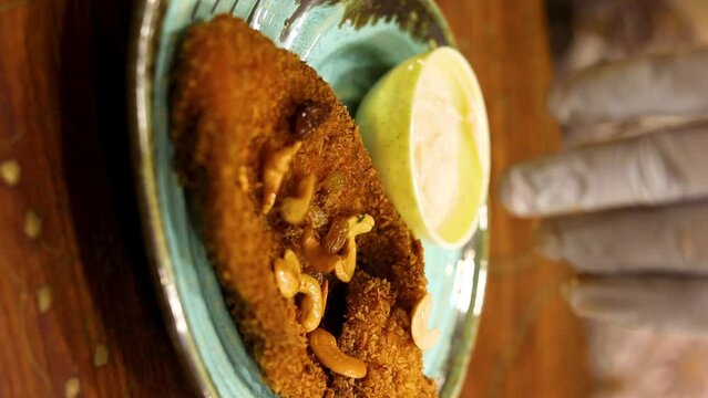 Deep fried fish garnished with cashew served with creamy sauce