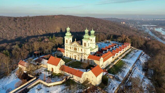 Camaldolese monastery and church in Bielany, Cracow, Poland
Camaldolese monastery and baroque church in the wood on the hill in Bielany, Krakow, Poland , Aerial 4K video in sunset light in winter. Far