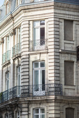 Facade of a beautiful old tenement house in France, historic French architecture.