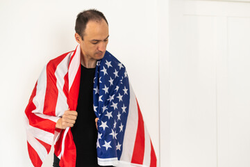 Man standing and putting country flag around the shoulder