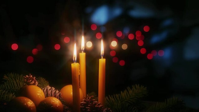 Candles and citrus fruit decoration with flickering lights, bokeh background