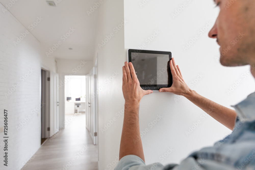 Poster automation, internet of things and technology concept - man looking at tablet pc computer at smart h