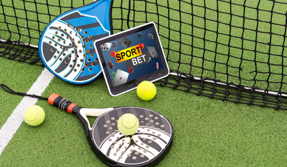 top view of tennis racket and ball near digital tablet with blank screen on green grass, sports...