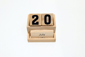 20th of July wooden perpetual calendar. Shot close up isolated on a white background