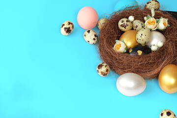 Easter eggs in a nest on a blue background. Copy space. Easter day.