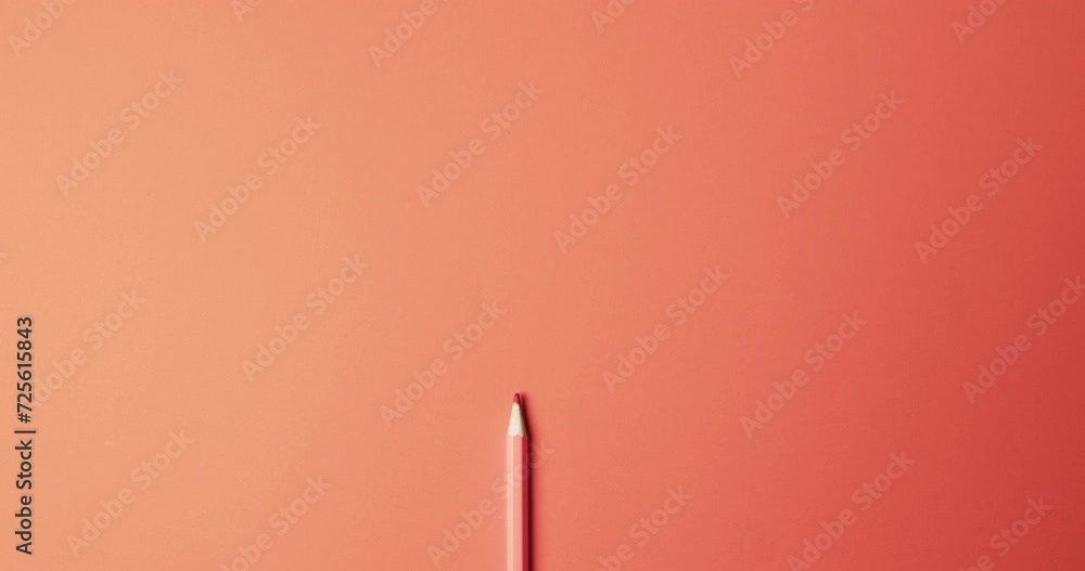 Wall mural Overhead view of red crayon with copy space on red background, in slow motion