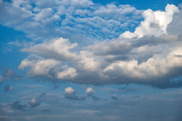 White and grey fluffy cloud on blue sky background texture. Heavy storm cumulus cloud. Copy space