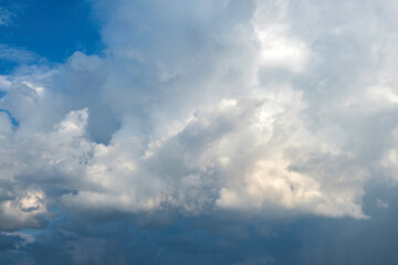 White and grey fluffy cloud on blue sky background texture. Heavy storm cumulus cloud. Copy space