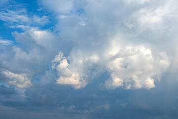 White and grey fluffy cloud on blue sky background texture. Heavy storm cumulus cloud. Copy space