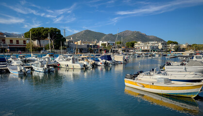 Fototapeta na wymiar Nea Makri harbour, Attica Greece. Fishing boat moored in Aegean calm sea. Greek sun and blue sky.